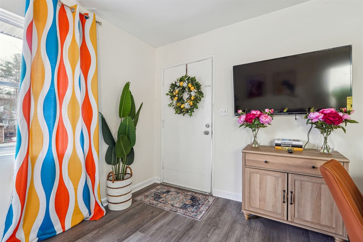 Enjoy a cozy living room featuring a comfortable couches, a TV for your entertainment, and a window with a lovely view outside, perfect for relaxing and unwinding.