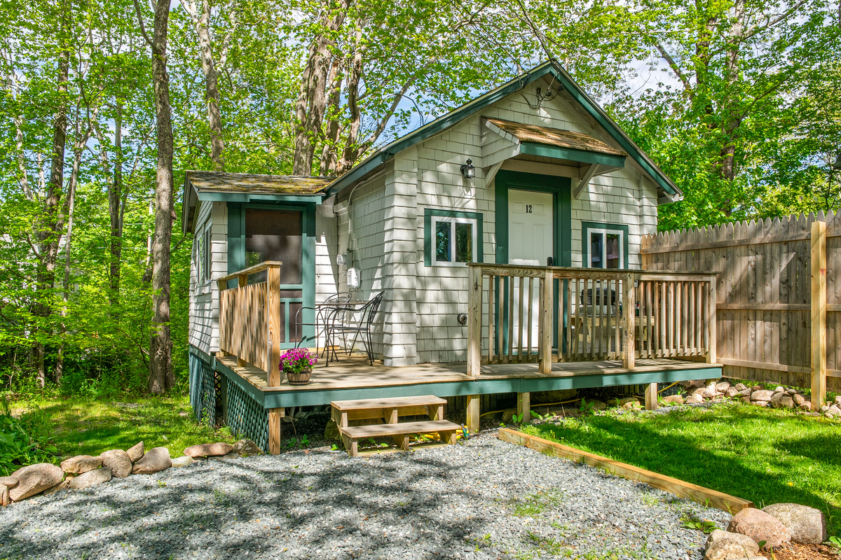 A closer look at your private cabin layout. From the sunlit front deck to the attached screen room, this cozy setup provides total trailside comfort. Unwind in the forest shade and get ready to experience the ultimate way to DO Acadia.