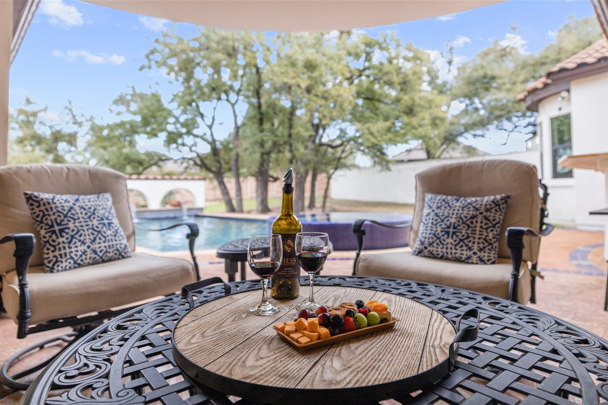 "Poolside bliss! 🏊‍♂️ Escape the heat in our lovely covered patio, where comfort meets stunning views. Perfect for morning coffee or evening cocktails!"