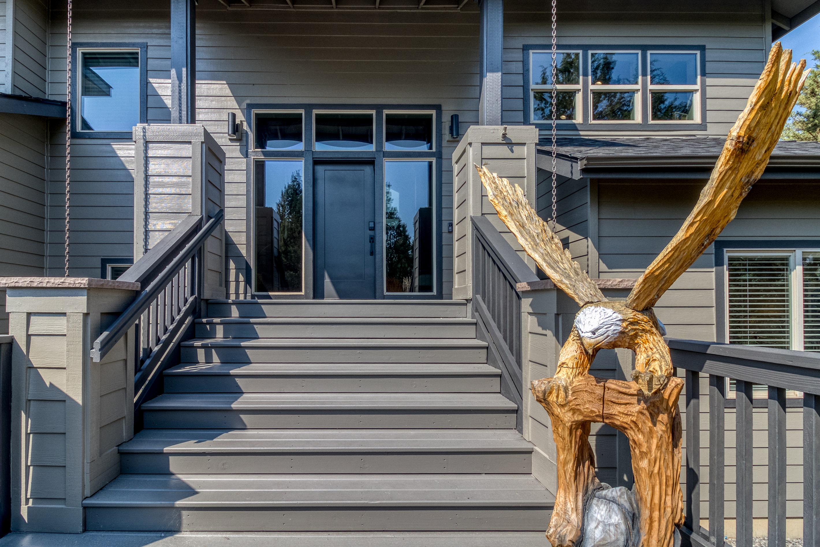 Welcome in with a touch of artistry. 🦅
Our home's exterior entrance features a striking carved wooden eagle.