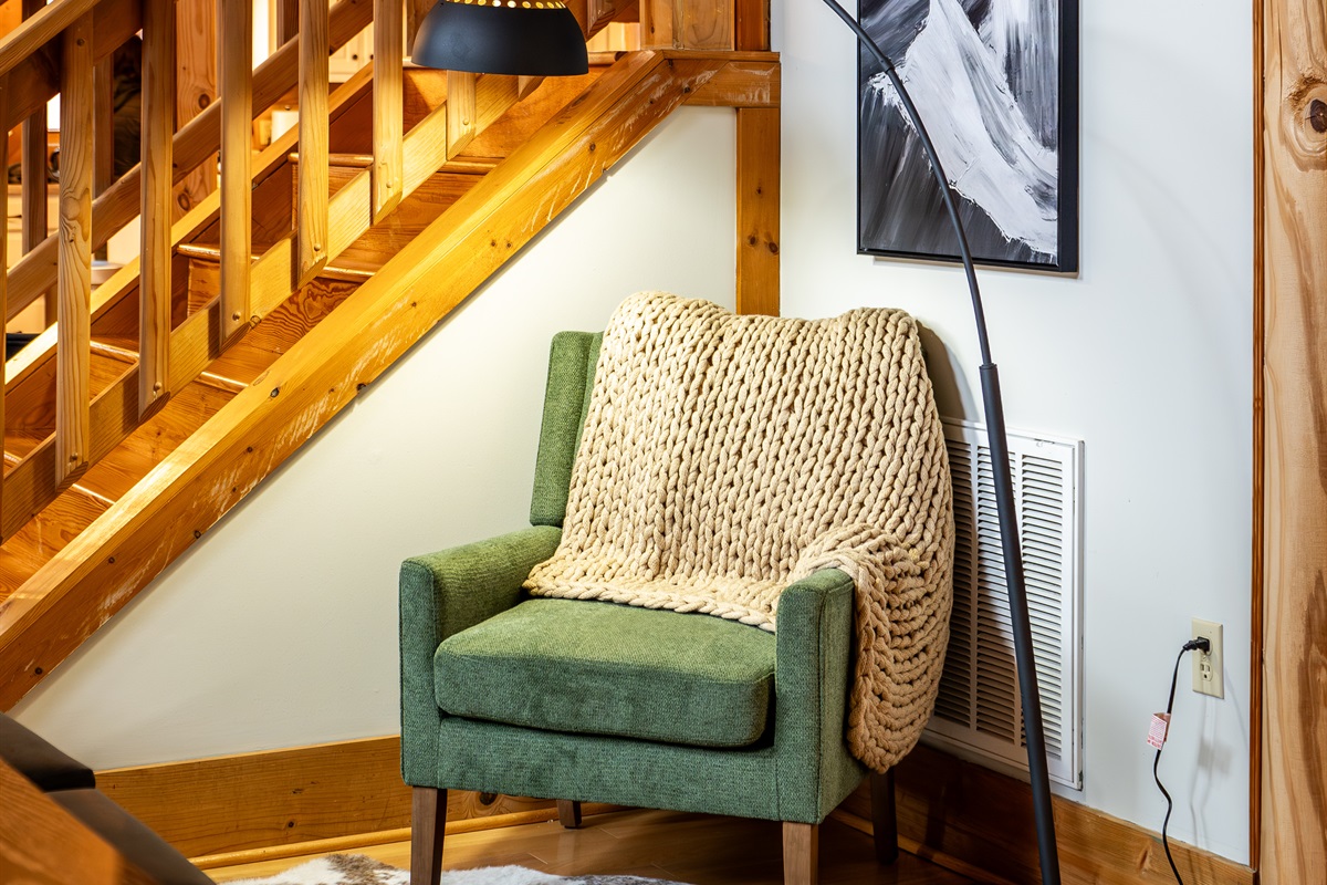Cozy reading nook tucked under the stairs.