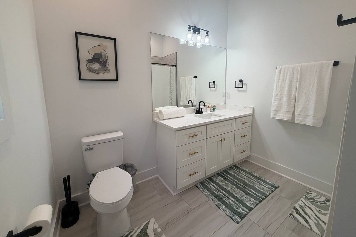 Bathroom connected with downstairs bedroom with king bed.