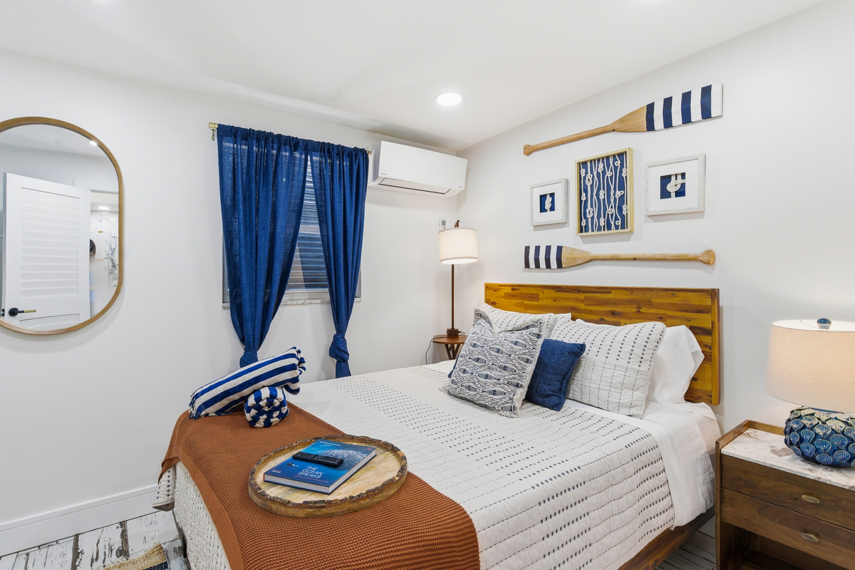 Bedroom #2 has a nautical-themed bedroom wraps you in navy, warm wood, and seaside charm.