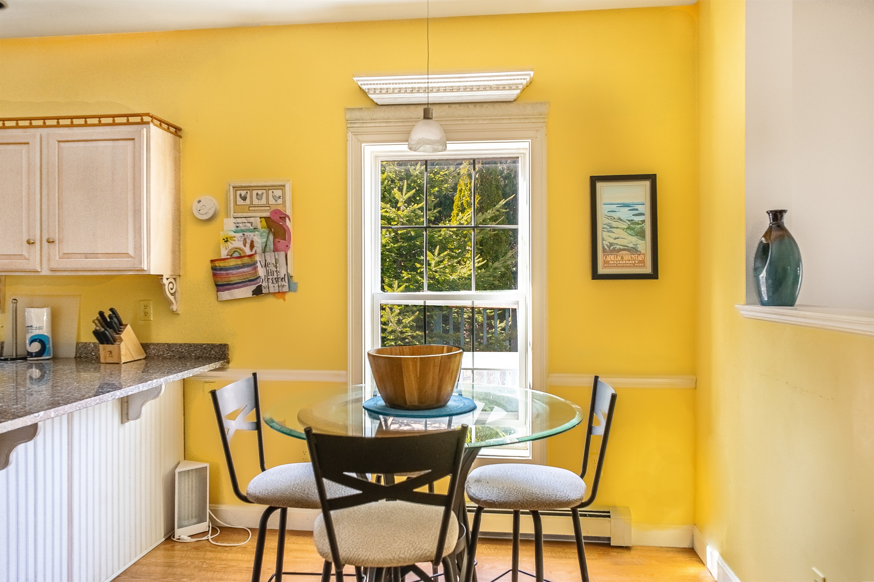 The sunlit breakfast nook seats four and is the perfect spot for morning coffee or planning your day. Overlooking the yard and deck, this cozy corner offers a bright, cheerful space to fuel up before heading out to explore Southwest Harbor.