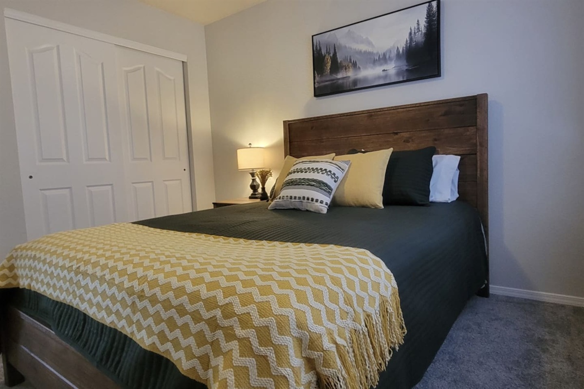 Bedroom features a queen bed, closet space, and a cozy setup for a good night’s sleep.