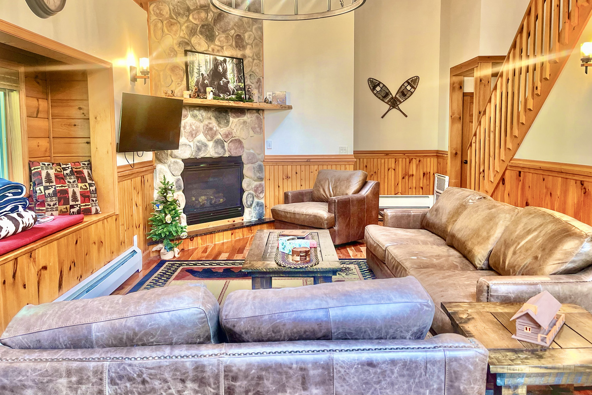 The living room staircase leads to the 2nd-floor bedrooms and bathroom. The main-floor bedroom, and stairs to the lower-level ensuite bedroom and game room, are located off the living room.  