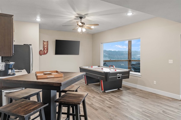 Rec Room has an air hockey table, pub table that seats four, TV and a kitchenette with coffee maker, large refrigerator/freezer with ice maker. Perfect area for the family to spend time together.