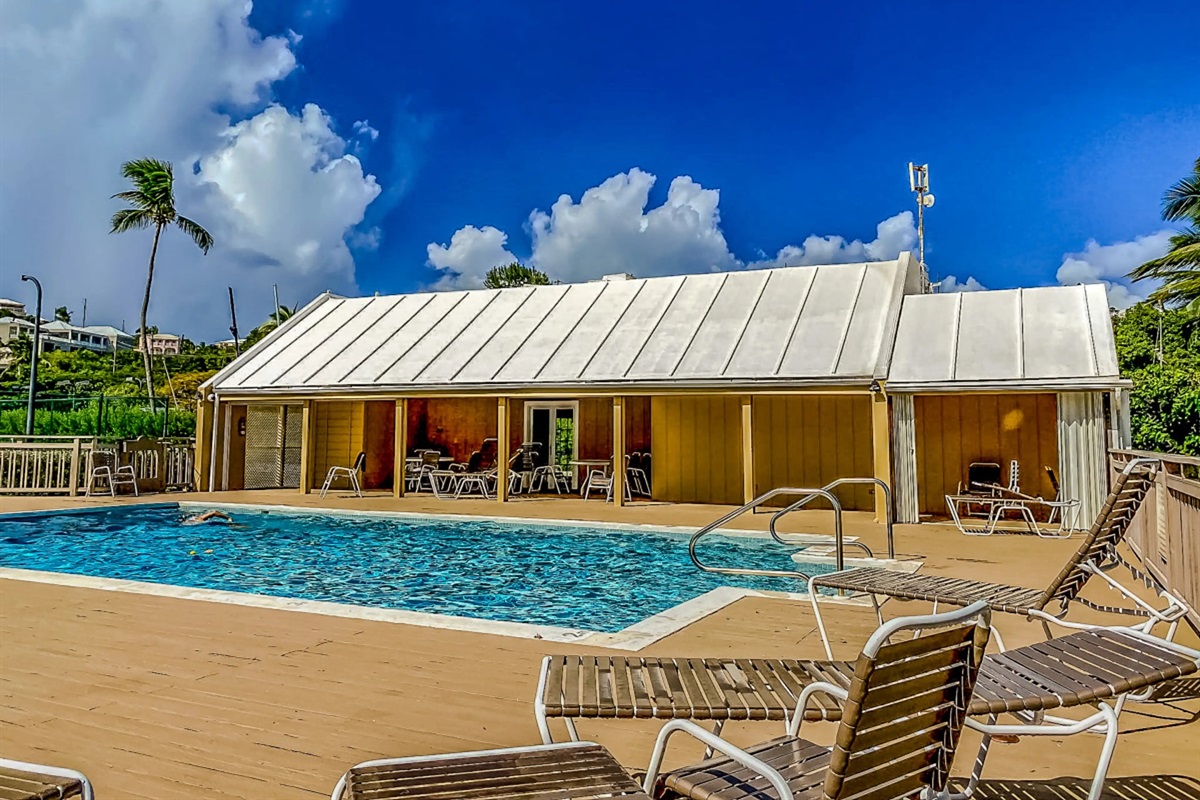 Enjoy resort amenities including a sparkling pool surrounded by palm trees and peaceful scenery.