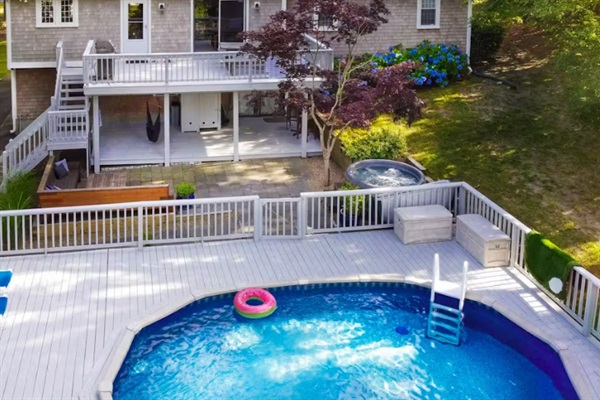 View of the back deck, swimming pool, and hot tub