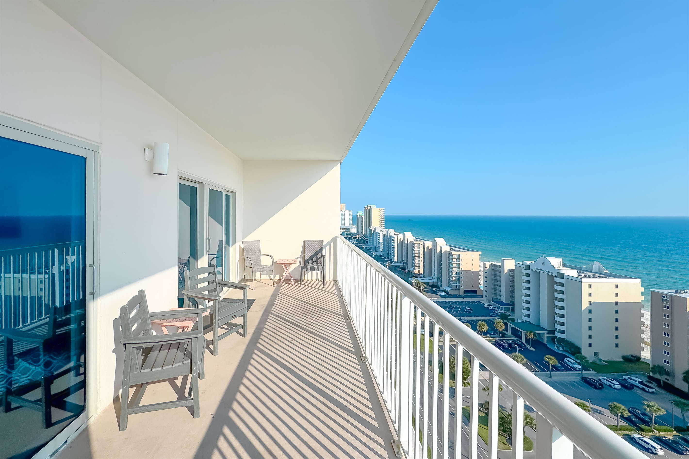 Gain a new perspective on coastal beauty with this panoramic view.  Witness the vastness of the beach and the shimmering sea.