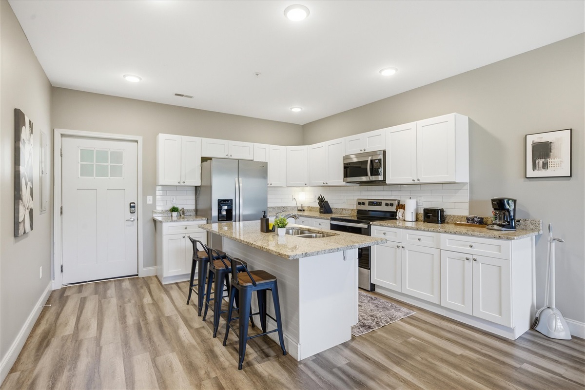 Walk into Unit 1 and take it all in—the full layout opens right up, giving you a clear view from the front door through the kitchen and into the living space. Easy, open, and ready to use.