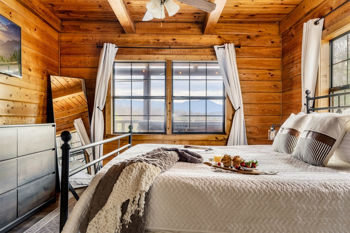 A well-equipped bedroom with modern wooden amenities. This whole region is surrounded in lovely natural scenery.