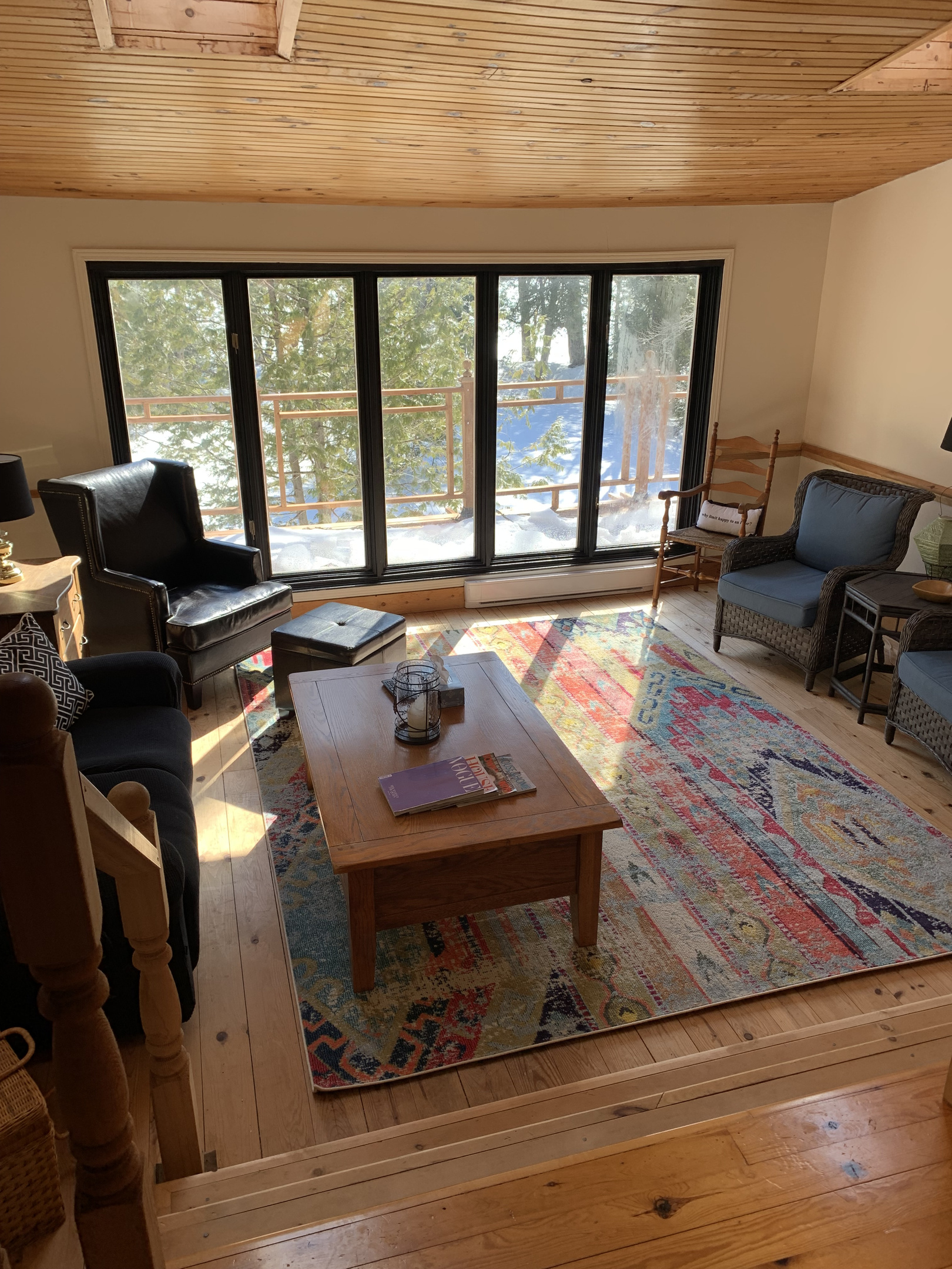 Living room seating with sliding door access to wrap-around deck