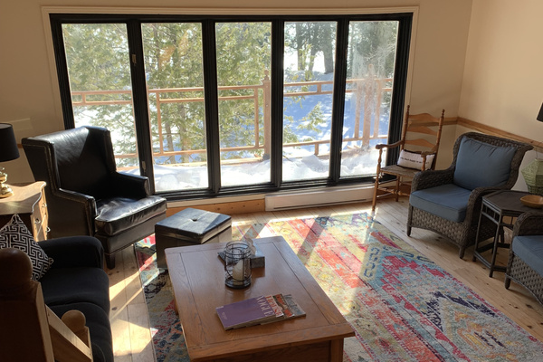 Living room seating with sliding door access to wrap-around deck
