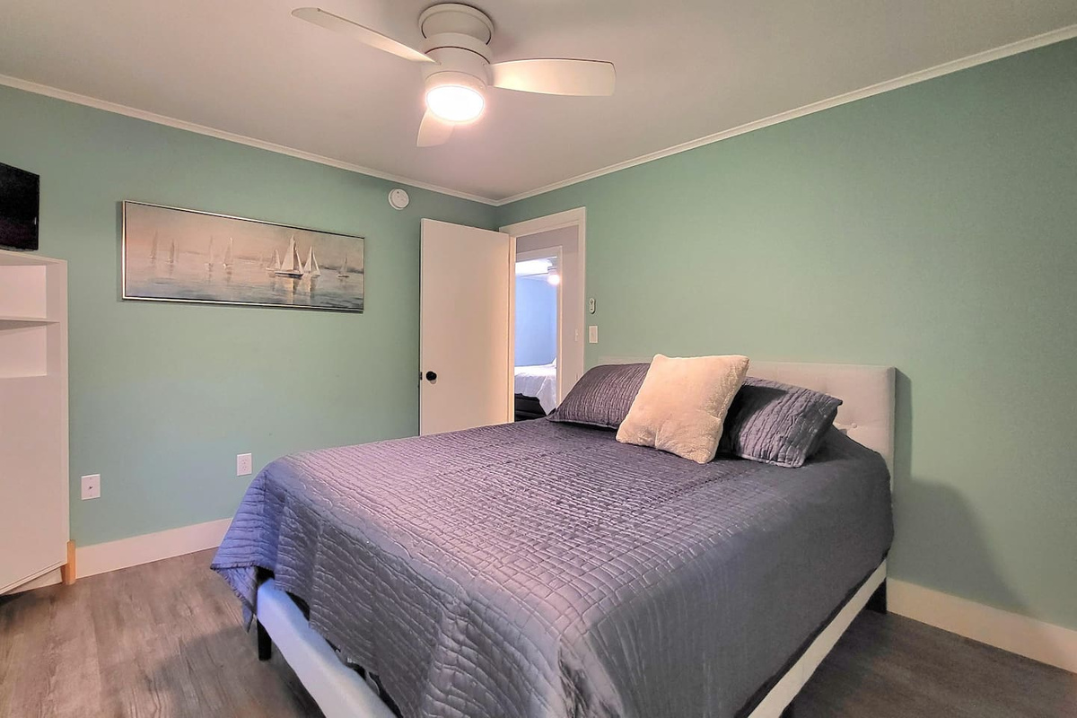 Primary bedroom with queen bed and full bath