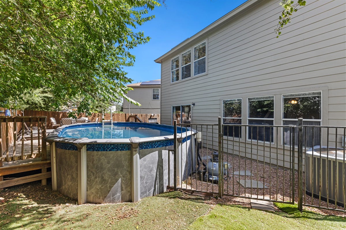 Pool deck and above-ground pool with surrounding patio in a fully fenced backyard. Swim and lounge in the San Antonio sunshine — private outdoor space exclusively for your group of up to 10.