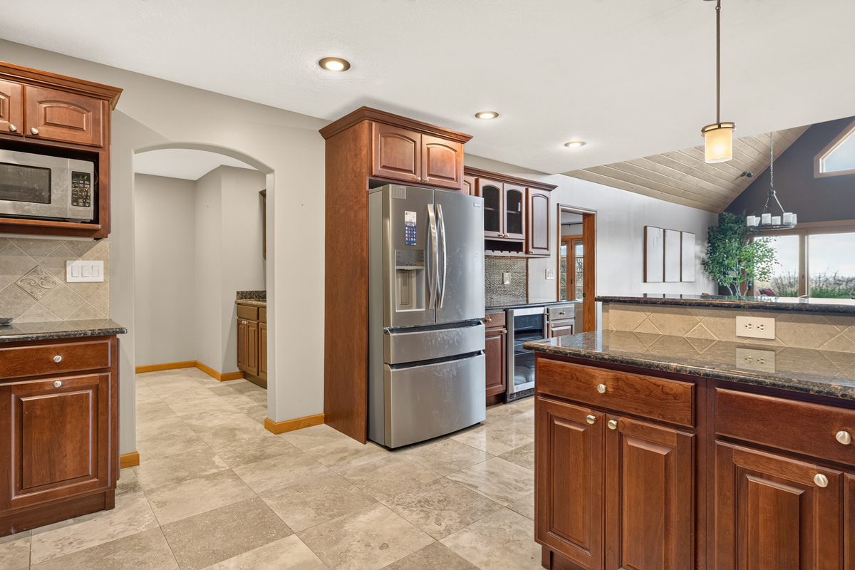 Kitchen with stainless steel refrigerator