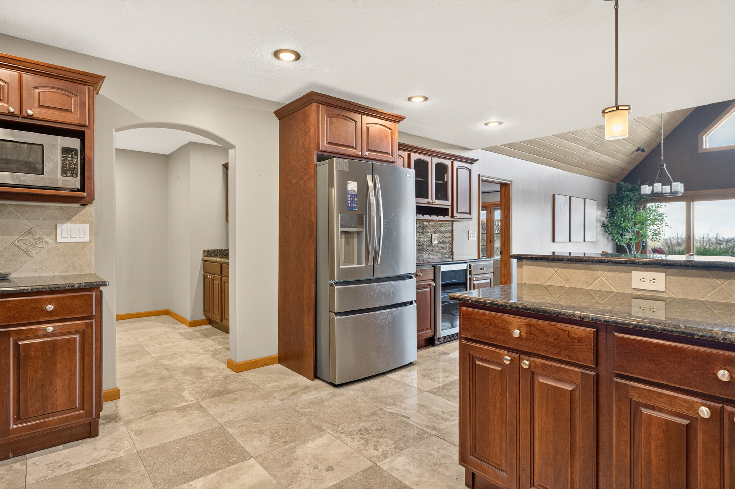 Kitchen with stainless steel refrigerator