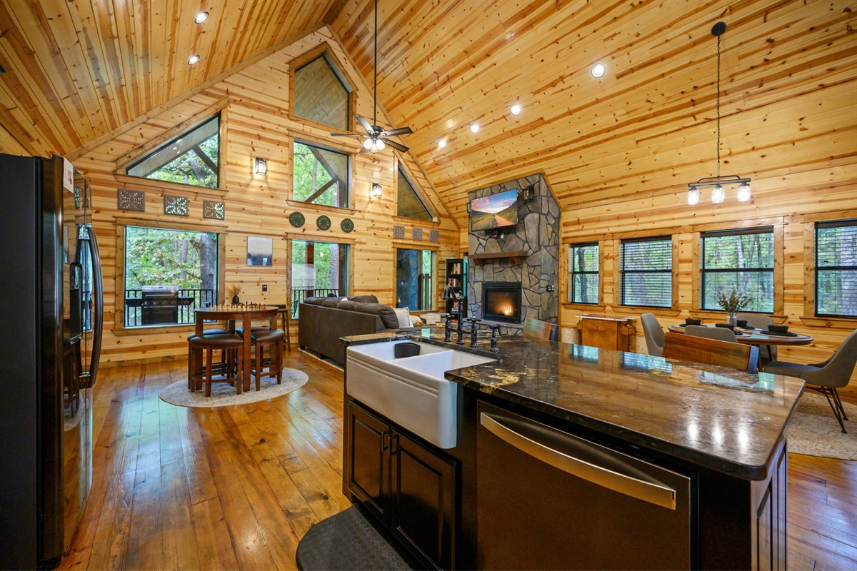 There are picture windows to enjoy the forest from the open concept living/dining/kitchen area.