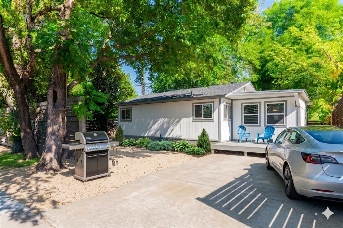 yard with grill , sitting chairs, park on driveway