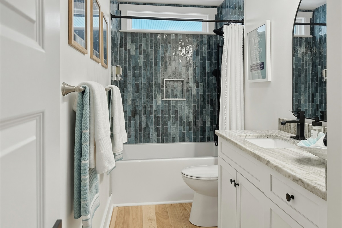 And a beautifully tiled shower/tub combo.