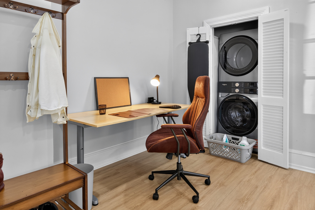 Dedicated work desk with USB charging, ergonomic chair, and high-efficiency in-unit washer/dryer closet.
