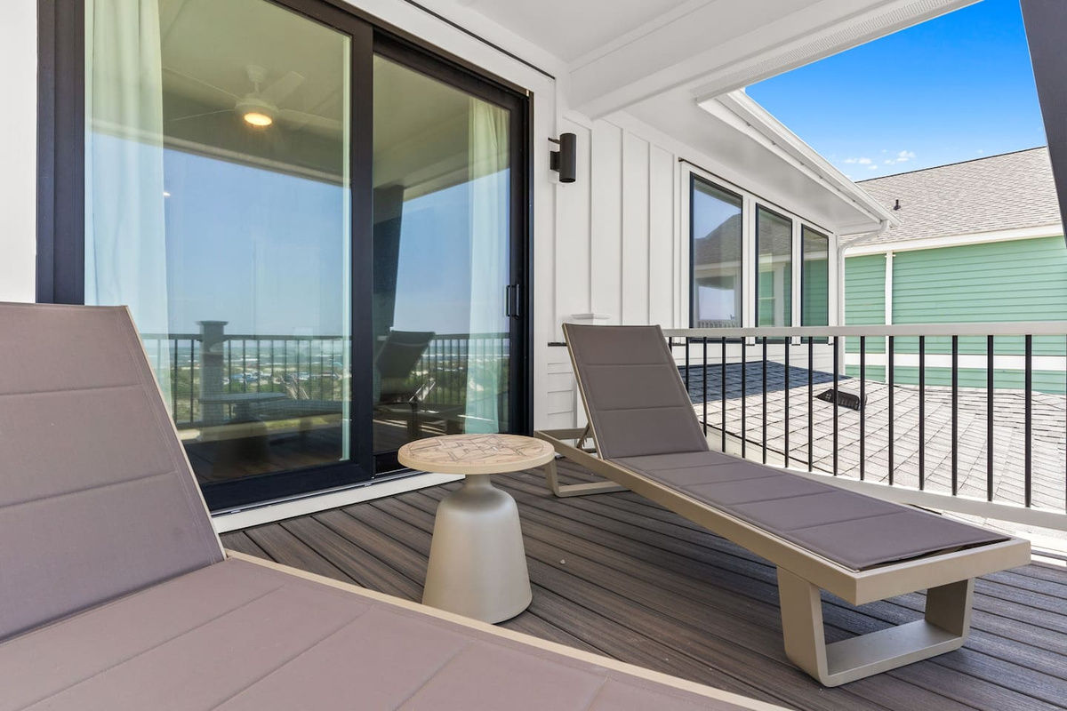 Step outside your primary suite and into your own private oasis. Relax on two chaise loungers while taking in sweeping views of the pool, beach volleyball court, and ocean beyond.