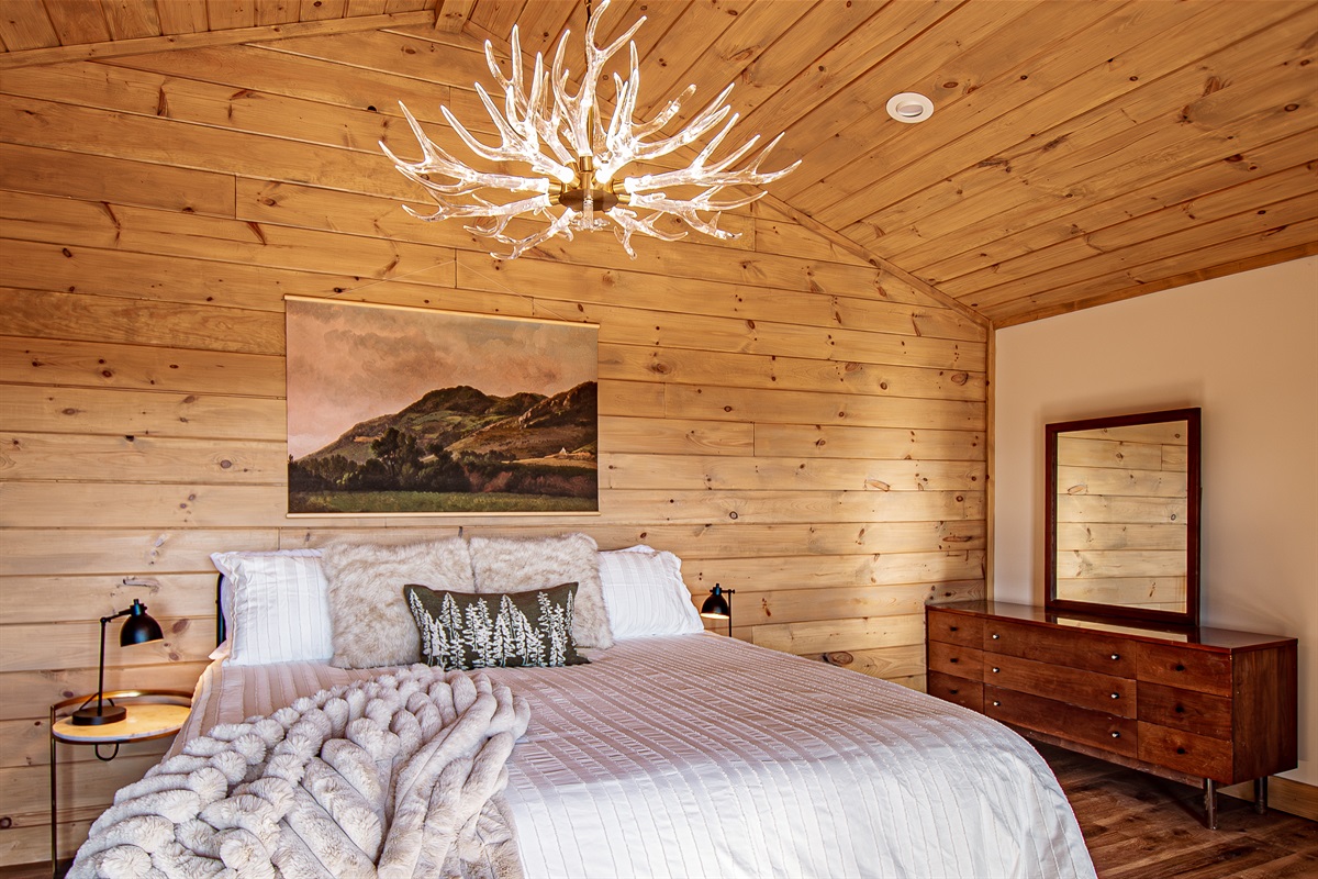 Relax in a spacious primary suite while you take in a wall of mountain views! Dancing pole for extra fun.