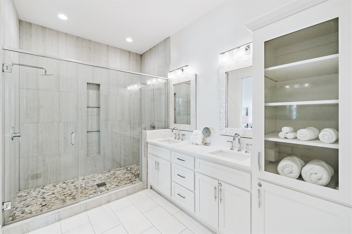 Second floor master ensuite bathroom with double vanities and an oversized shower featuring dual shower heads.