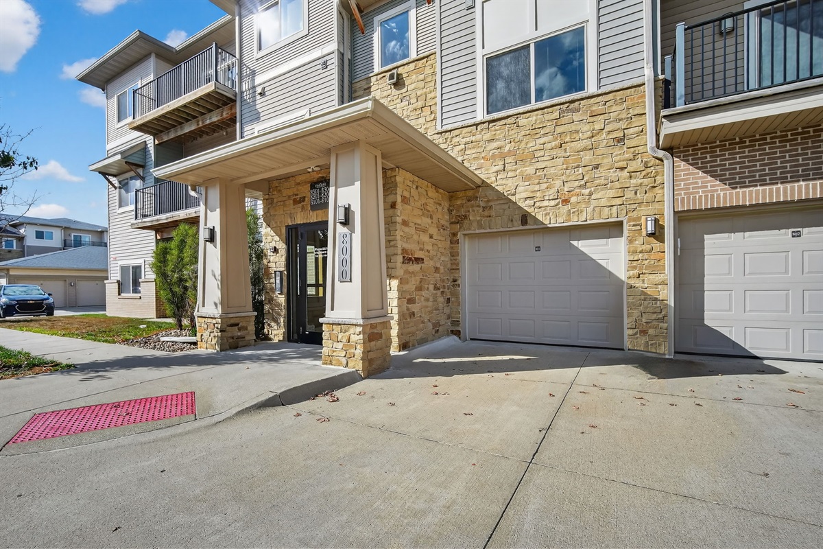 Arrive with ease at this modern stone-accented building featuring private garages and a secure entryway. Convenient parking and direct access set the tone for a seamless stay.