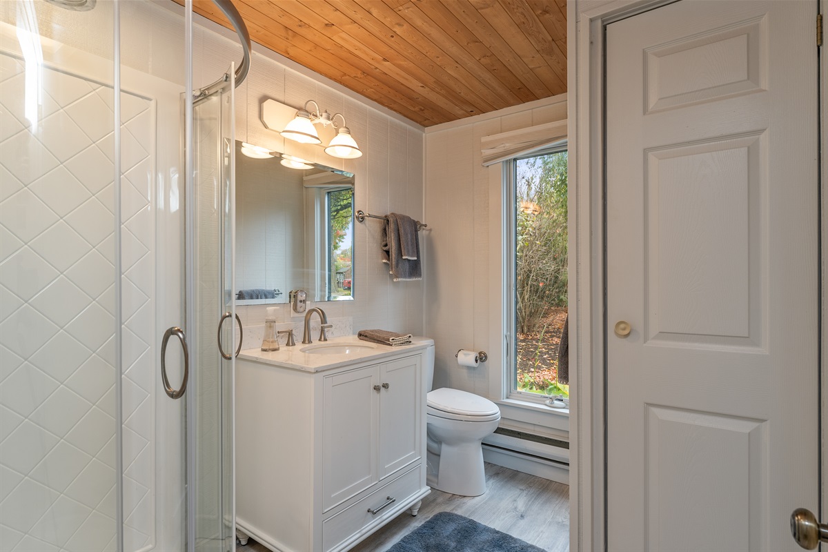 Elegant bathroom featuring modern fixtures and natural light — unwind in comfort.