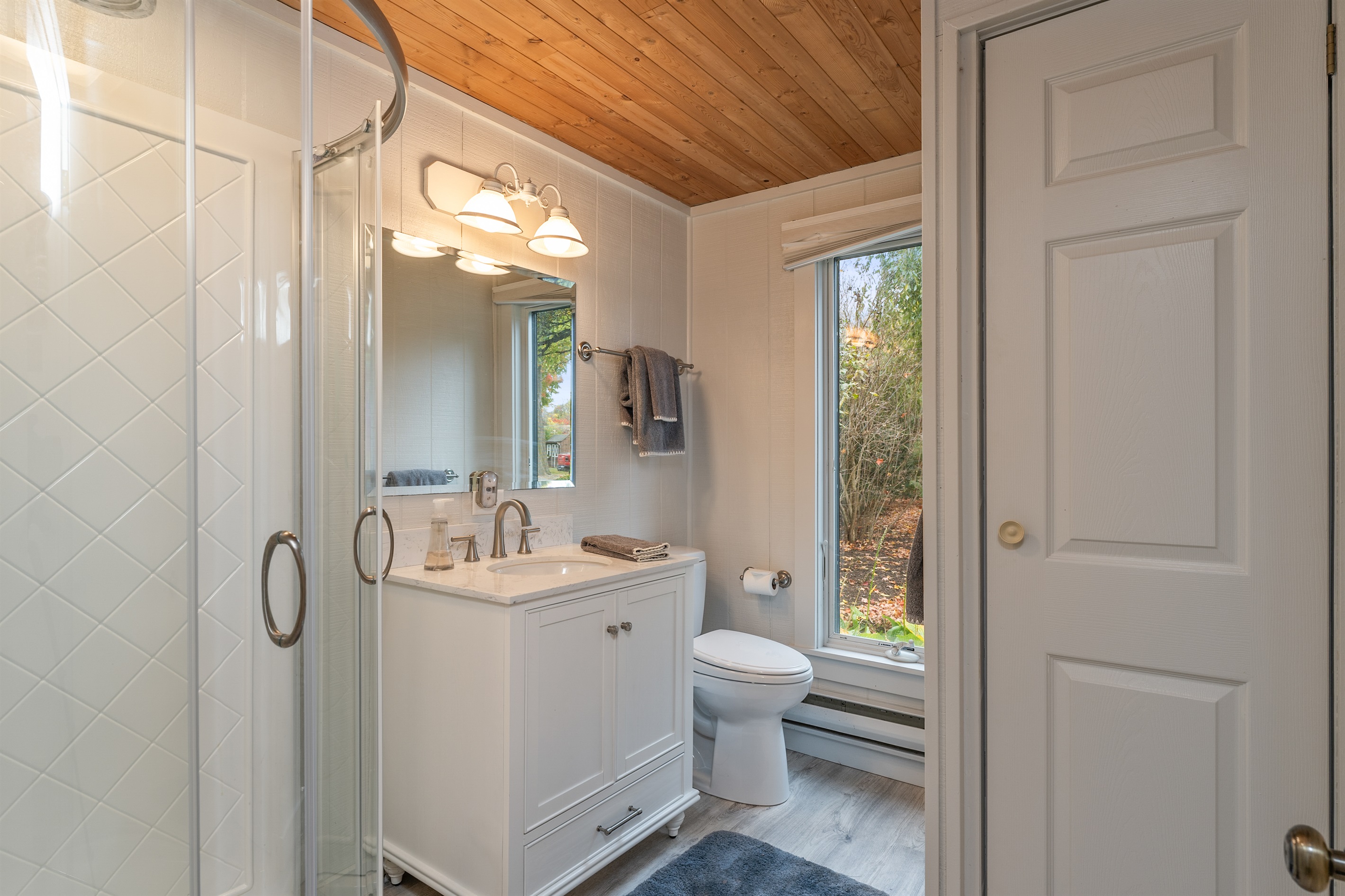 Elegant bathroom featuring modern fixtures and natural light — unwind in comfort.