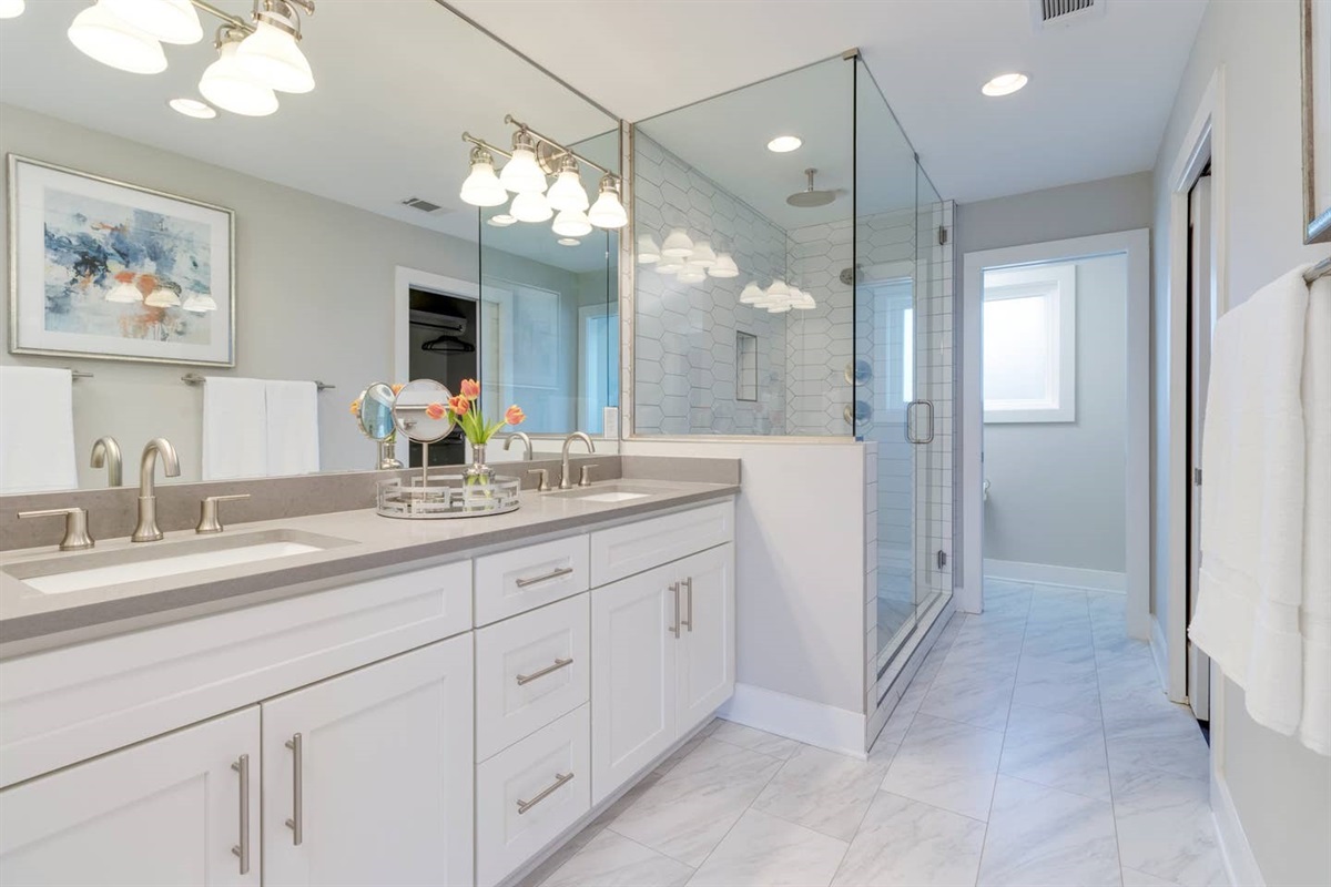 - Spacious double vanity with elegant lighting makes getting ready a breeze - Walk in glass shower with white tile adds spa like luxury to your daily routine - Soft hues, sleek finishes, and thoughtful touches define this modern bath