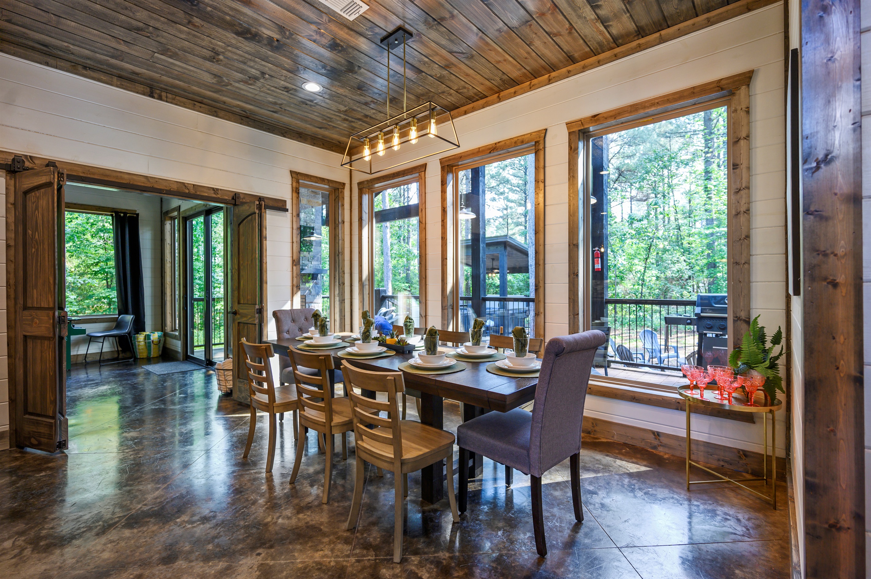Cozy dining nook surrounded by nature-filled windows