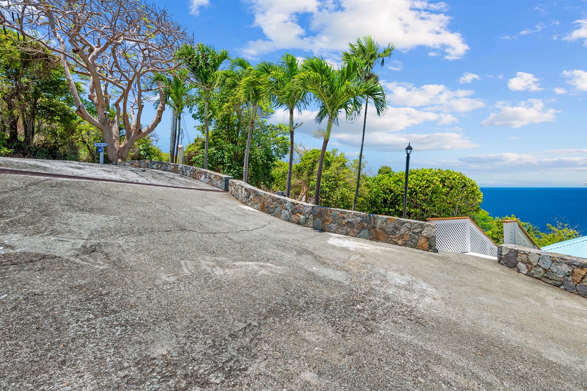 Slight downhill slope from the driveway to the stairs that lead to the cottage.