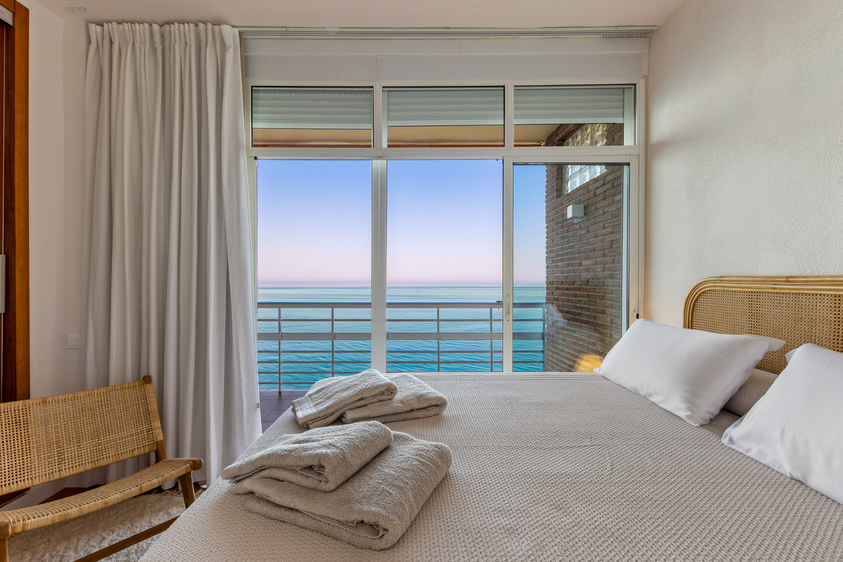 Evening calm in the bedroom as the sea changes colour at dusk.