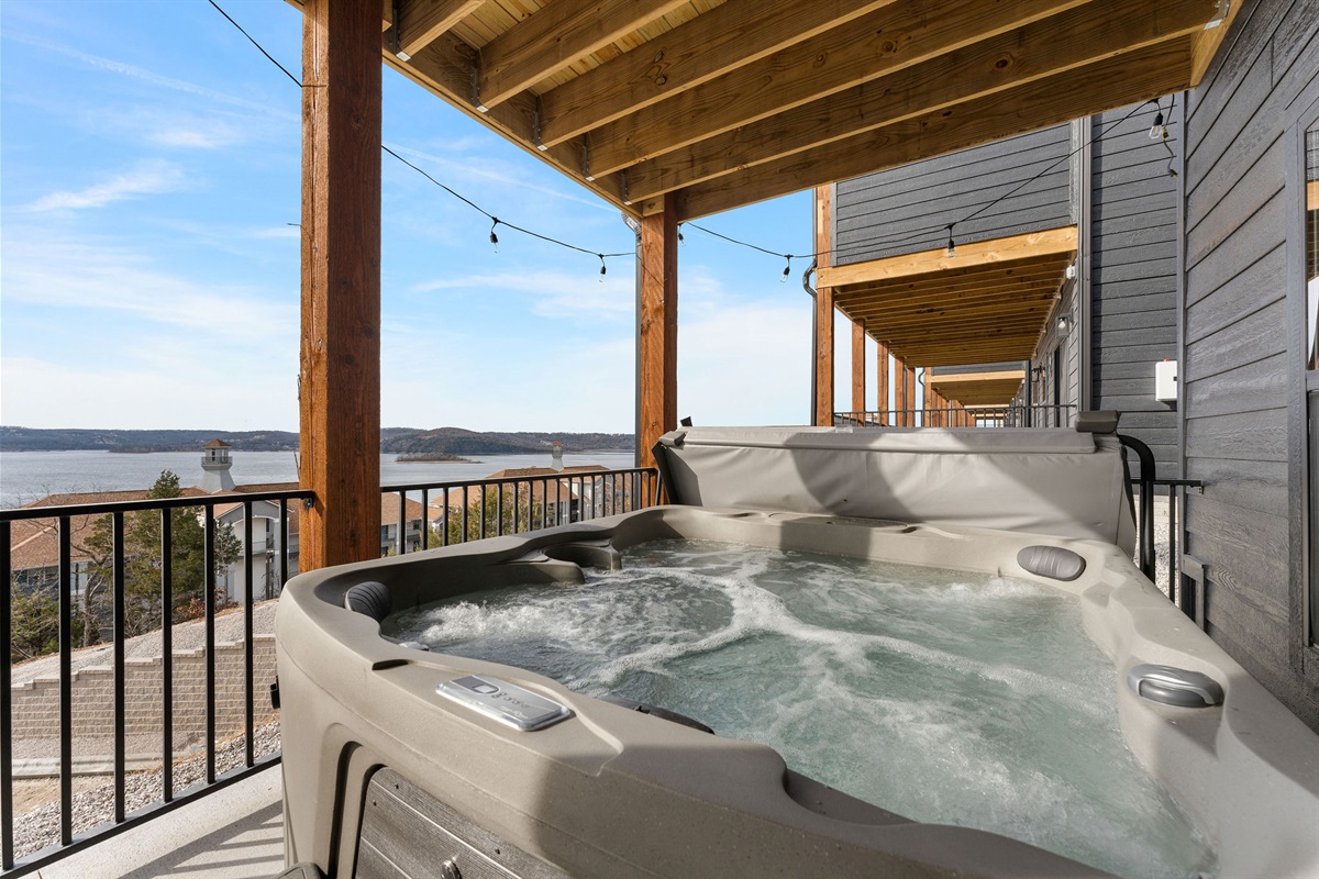 Soak in the hot tub while looking over the lake!