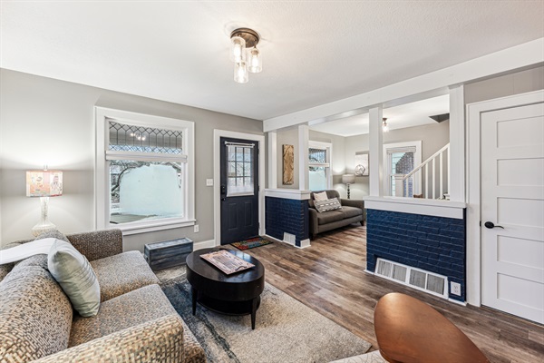 Living room into our cozy foyer with additional seating and desk area.