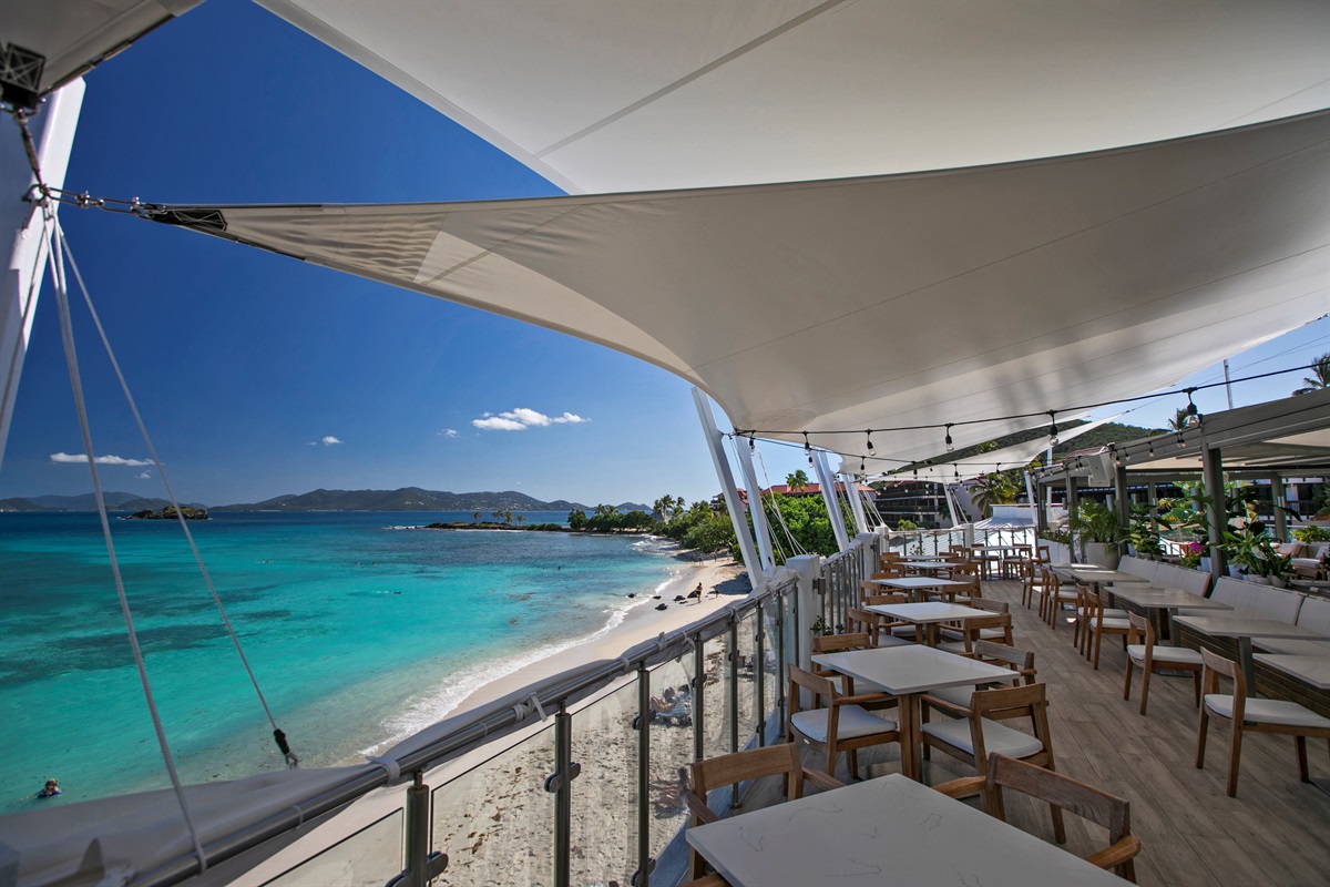 Outdoor dining area with plenty of seating&mdash;ideal for enjoying meals just steps from the beach.