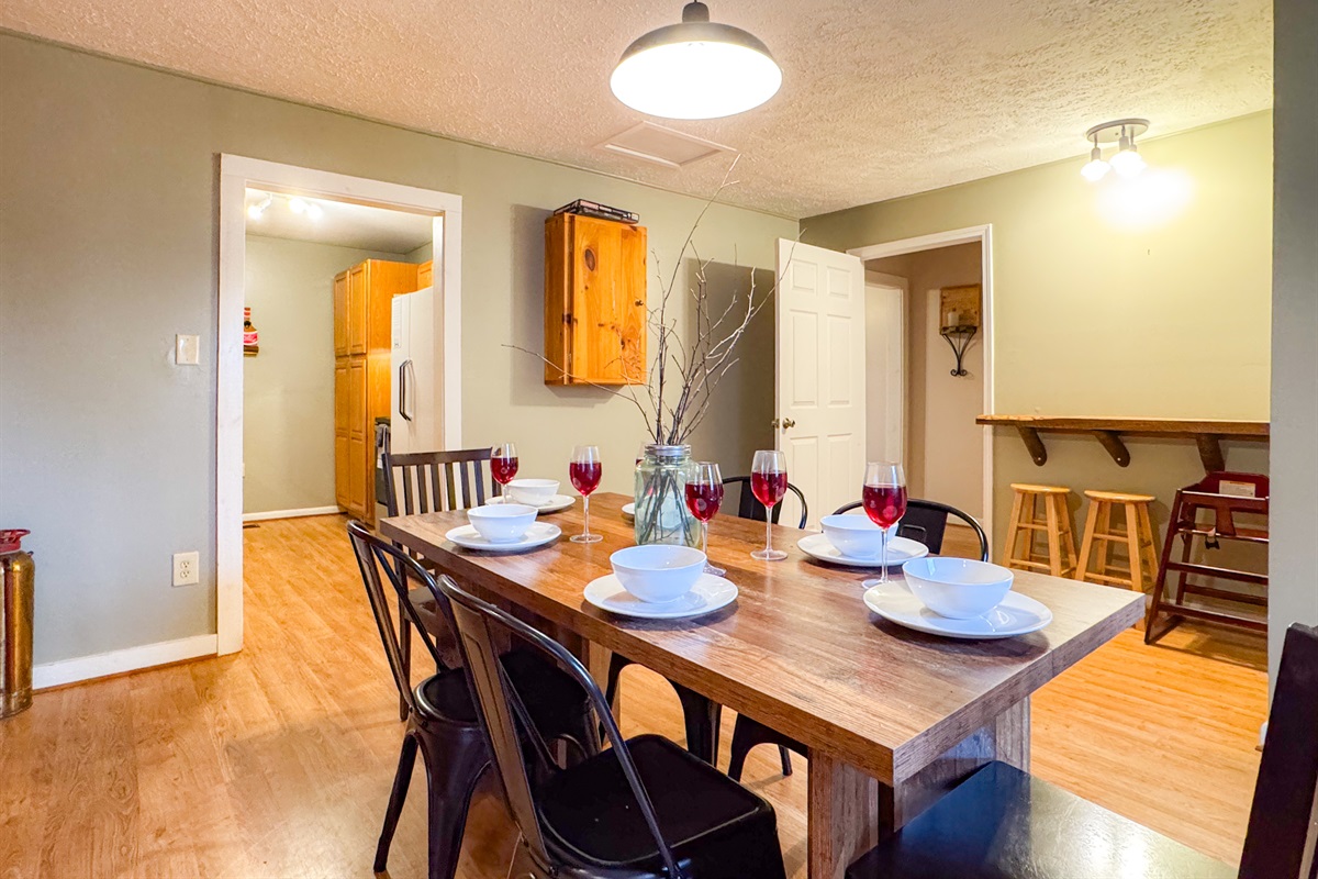 dining room area complete with seating for 6 at the table and a small bar top for 2 additional