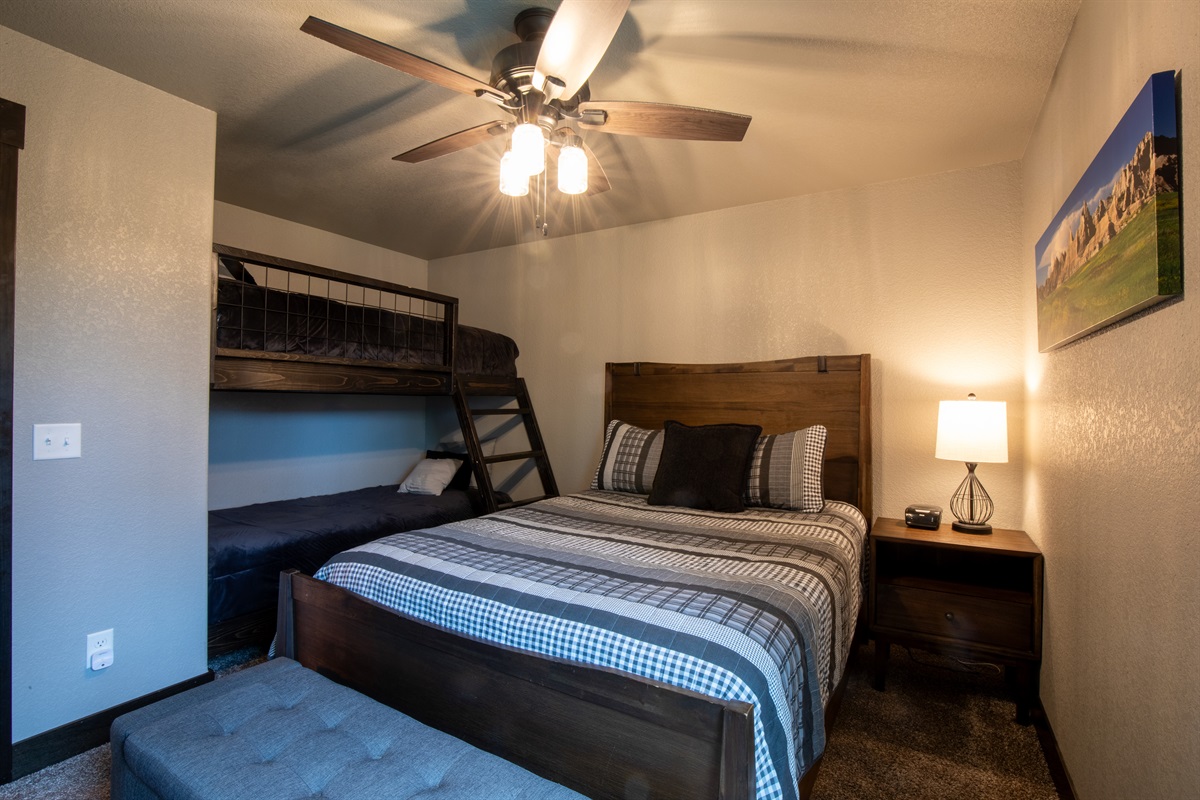 Family-friendly and spacious—this main floor bedroom includes a cozy queen bed and twin bunks, making it easy for parents and kids to rest and recharge together.