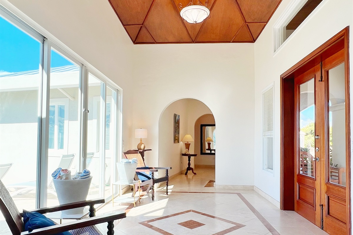 Grand entryways with natural light to greet you each day. Those doors on the left lead straigh out to the pool deck.
