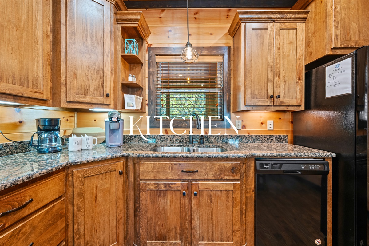 Fully equipped kitchen with stainless appliances and granite counters.