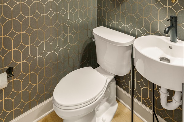Lower level half bath directly adjacent to the game room. 