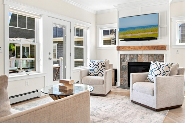 Natural light, comfortable seating, and a cozy fireplace create an inviting space to unwind.