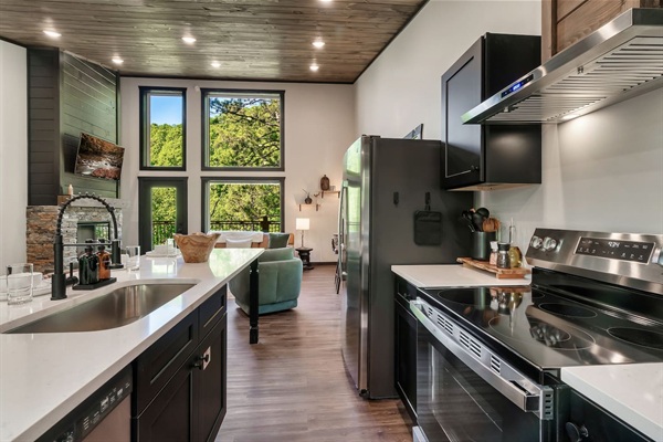 Modern kitchen with stainless steel appliances and open flow to the living area.