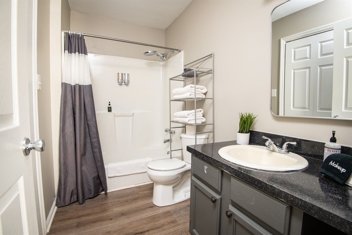 This ensuite bathroom is attached to the double queen room. Both bathrooms come complete with shampoo, body wash, conditioner, hand soap, and all the linens you need for a comfy stay.