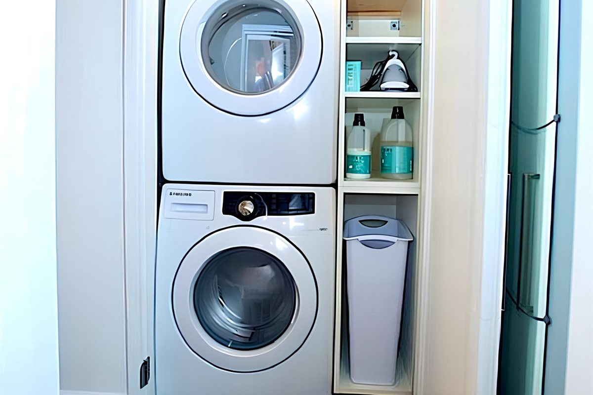 Inside the bathroom at Tradhuset (treehouse) guests will find a stacked washer/dryer are inside their own closet, along with laundry supplies, iron and ironing board