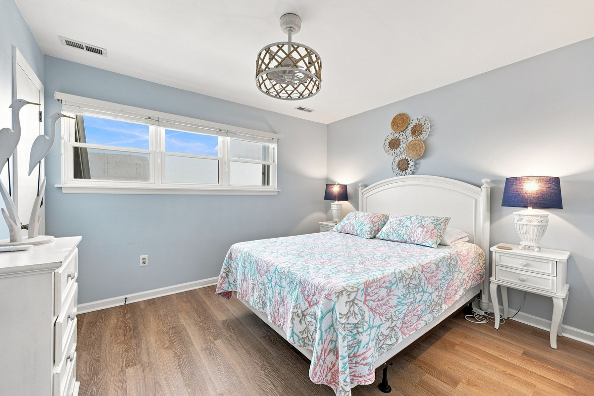 Bright and airy, this bedroom showcases charming coral decor and a cozy ambiance.