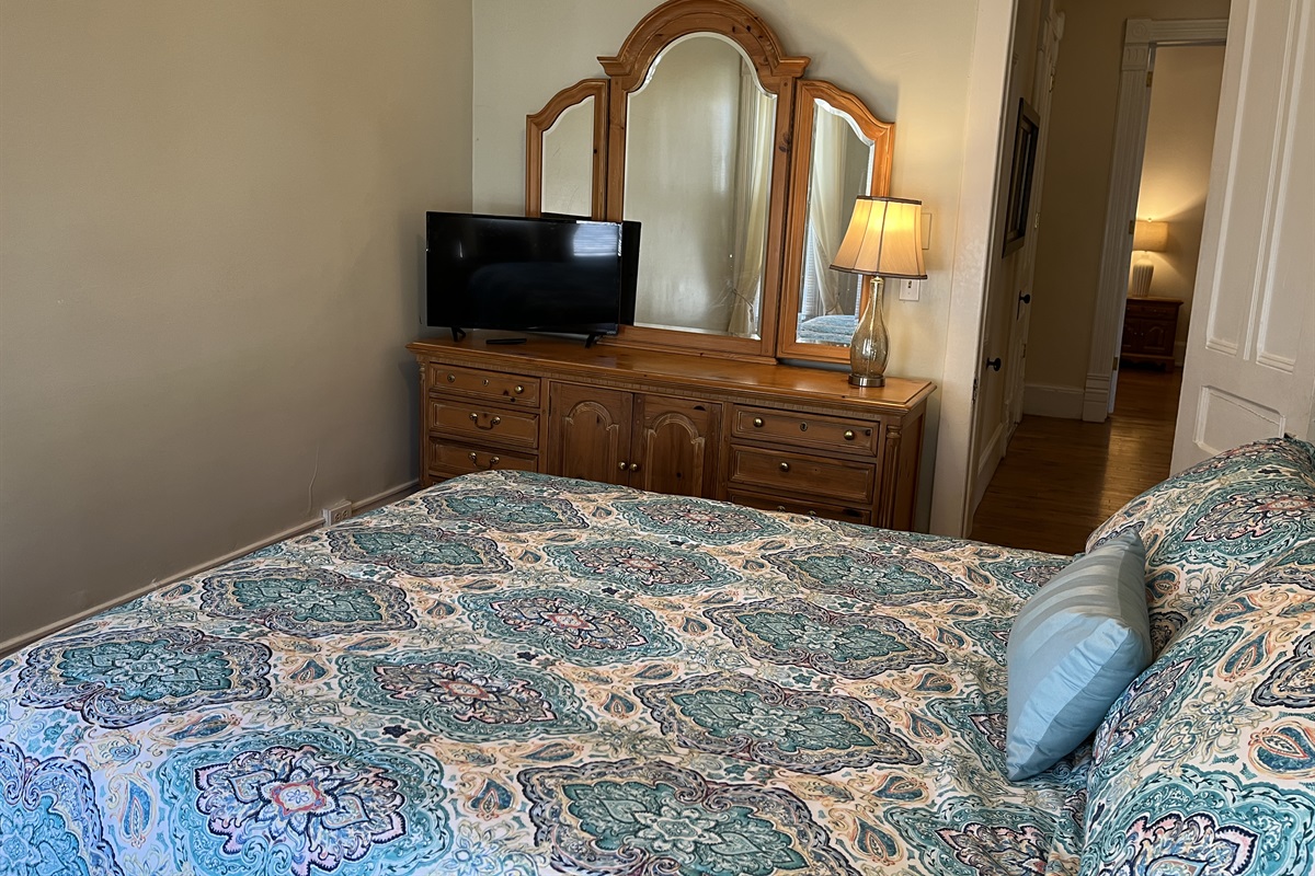 Queen bedroom #1 with hallway to bath room